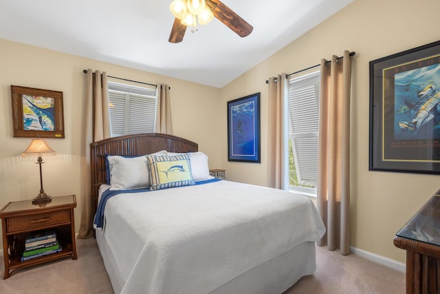 carpeted bedroom featuring vaulted ceiling and ceiling fan