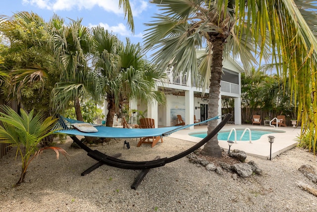 view of swimming pool with a patio area and a sunroom