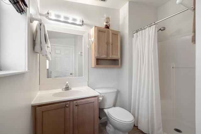 bathroom featuring vanity, toilet, and a shower with shower curtain