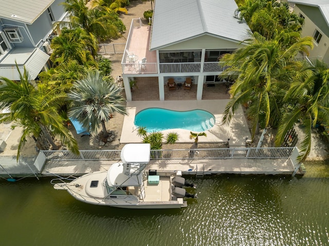 exterior space featuring a dock, a patio area, and a water view