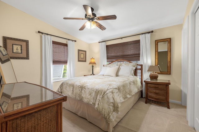 carpeted bedroom featuring vaulted ceiling and ceiling fan