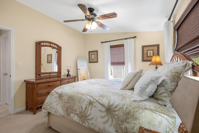 bedroom featuring vaulted ceiling, light carpet, and ceiling fan