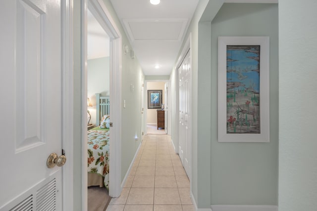 hall with light tile patterned floors