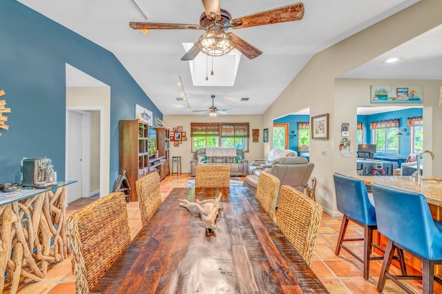 dining area featuring ceiling fan, baseboards, and vaulted ceiling