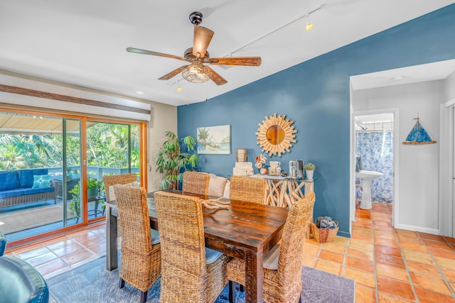 dining room with light tile patterned floors, baseboards, ceiling fan, and track lighting