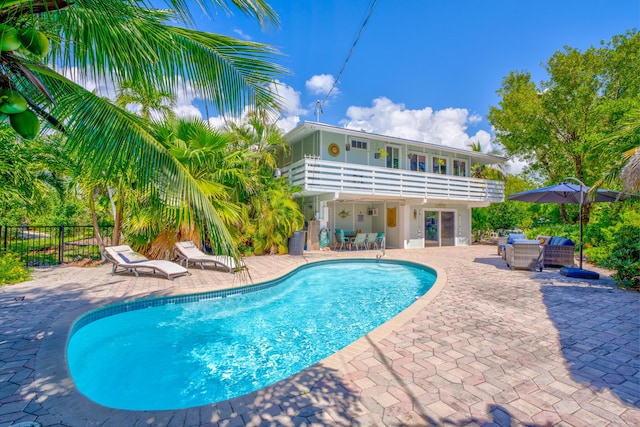 view of pool with a patio area, a fenced in pool, and fence