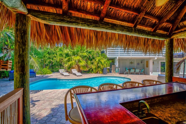 outdoor pool with a sink, a gazebo, and a patio area