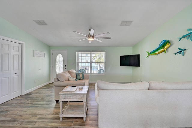 living room with hardwood / wood-style flooring and ceiling fan