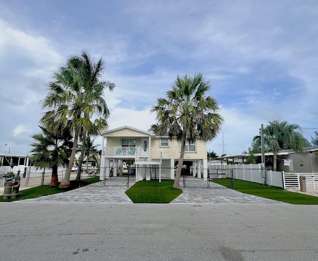 view of front of property with a balcony and a front lawn