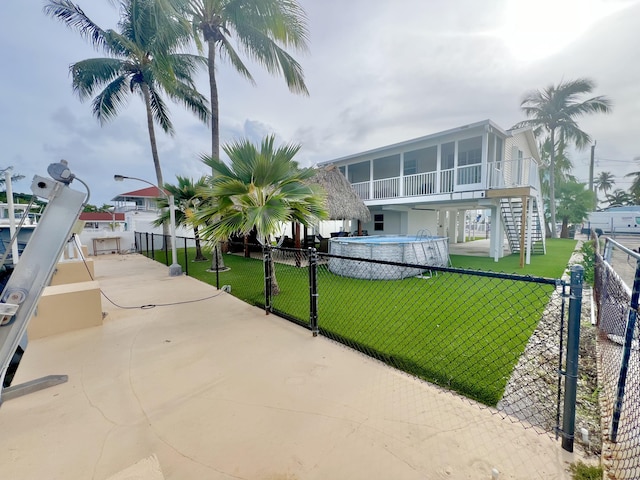 view of property's community with a swimming pool and a lawn