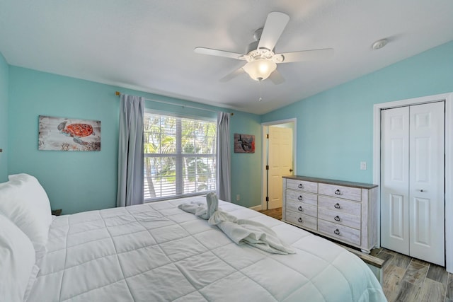 bedroom with hardwood / wood-style flooring, a closet, and ceiling fan