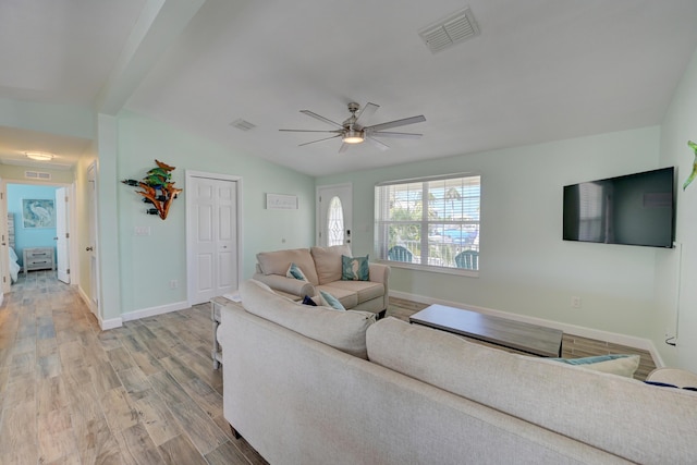 living room featuring ceiling fan, lofted ceiling, and light hardwood / wood-style flooring