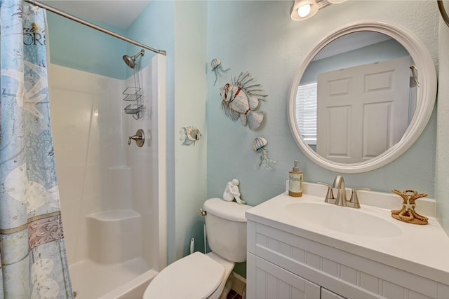 bathroom featuring vanity, toilet, and curtained shower