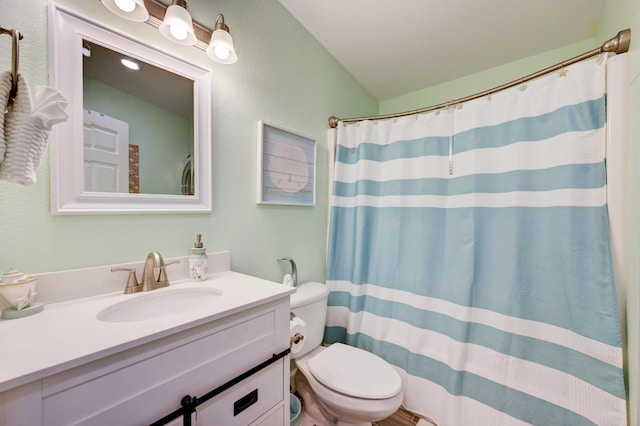 bathroom with vanity, curtained shower, and toilet