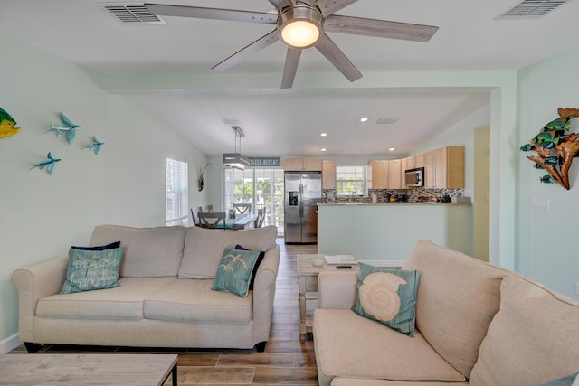 living room with vaulted ceiling with beams, hardwood / wood-style flooring, and ceiling fan