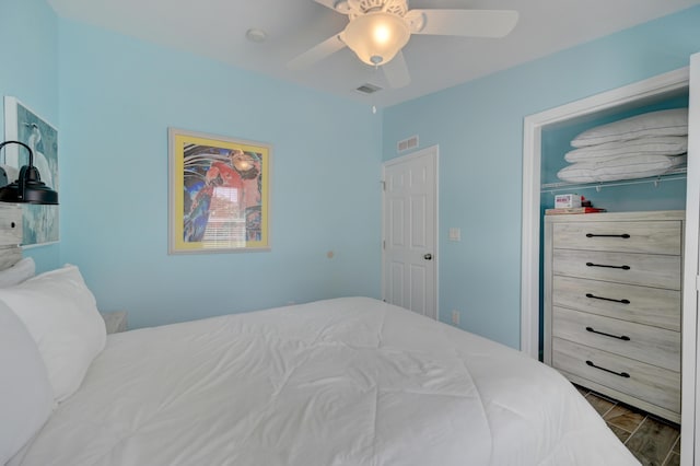 bedroom with ceiling fan and wood-type flooring