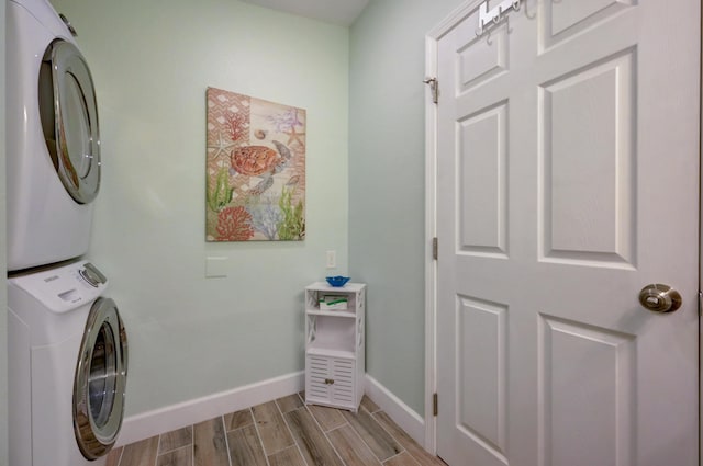 clothes washing area with stacked washer and clothes dryer