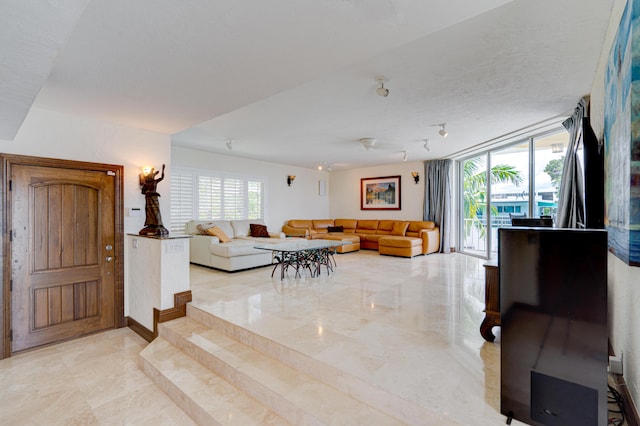 living room featuring floor to ceiling windows