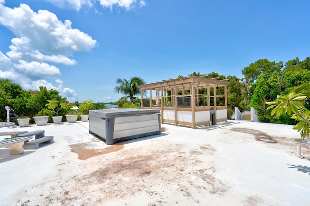 exterior space with a pergola, a hot tub, and a patio