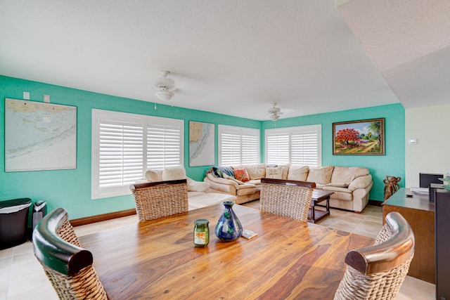 tiled dining space with ceiling fan