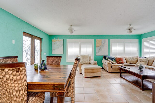 dining area featuring ceiling fan and light tile patterned flooring