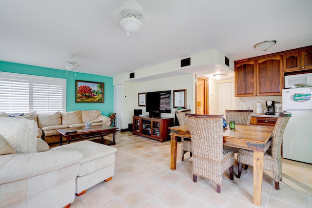 tiled dining room with ceiling fan