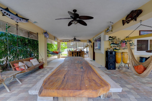 view of patio with a bar and ceiling fan