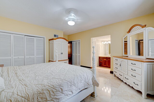 bedroom with multiple closets and ensuite bathroom