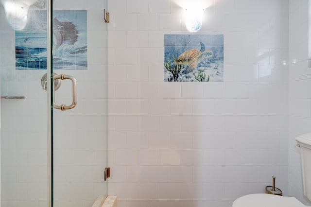 bathroom featuring an enclosed shower and toilet