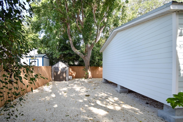 35 Rose Pl, Key Largo, FL 33037 - view of home's exterior with a fenced backyard, an outbuilding, and a storage shed