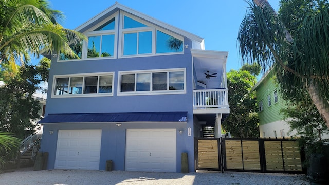 view of front of property with a garage and ceiling fan