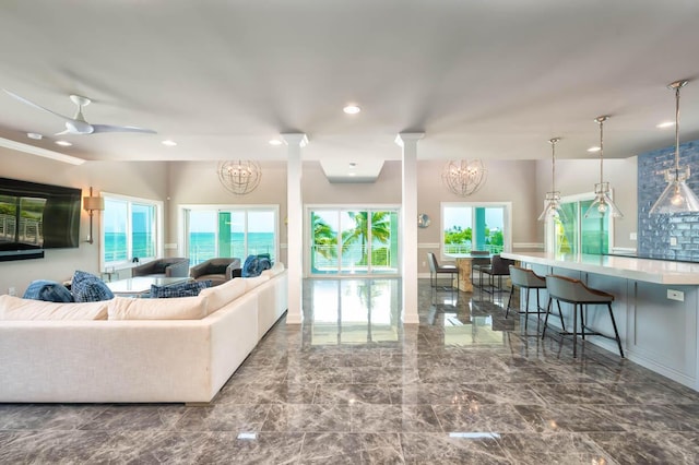 living room featuring ceiling fan with notable chandelier, decorative columns, marble finish floor, and recessed lighting