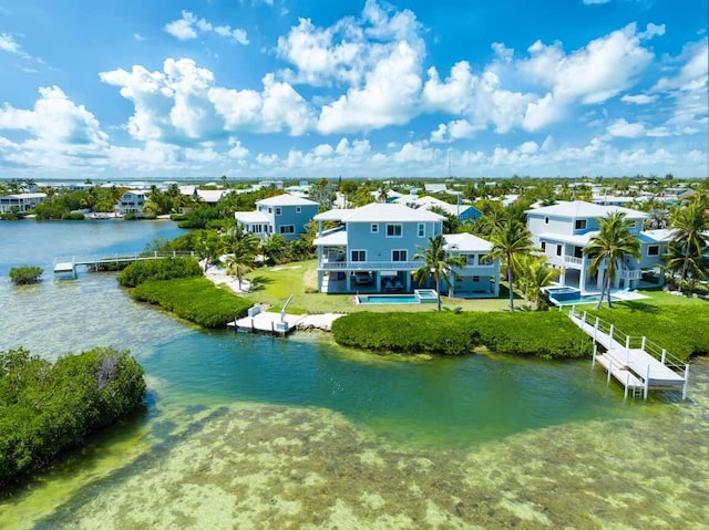 bird's eye view featuring a residential view and a water view