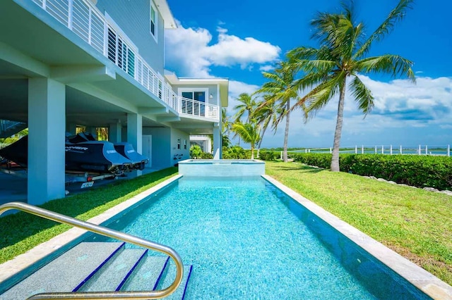 view of pool featuring a yard, a patio, and a pool with connected hot tub