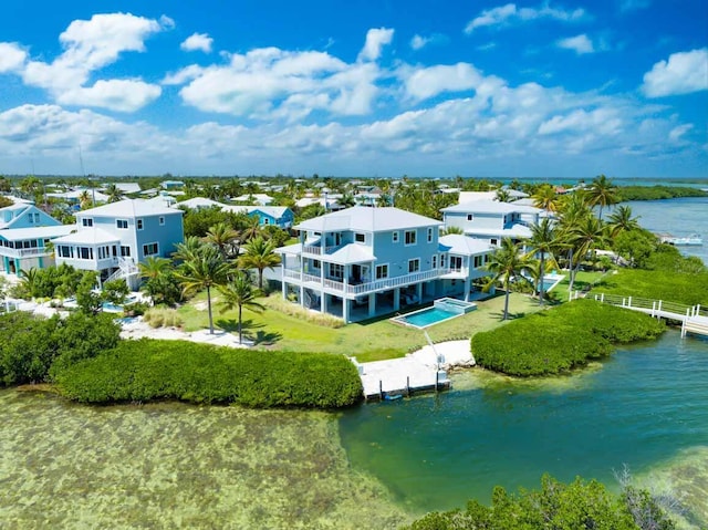 drone / aerial view featuring a water view and a residential view