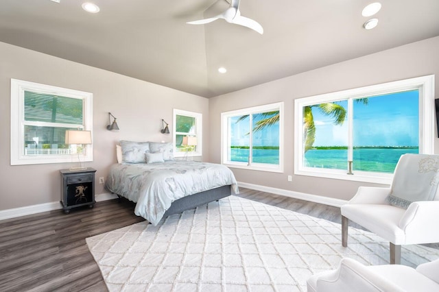 bedroom with recessed lighting, vaulted ceiling, wood finished floors, and baseboards