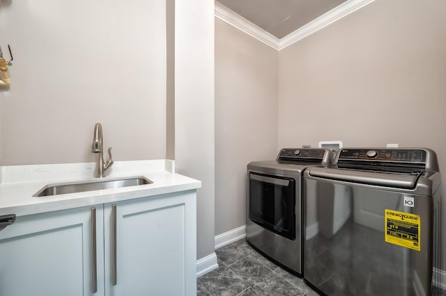 laundry area with a sink, crown molding, baseboards, separate washer and dryer, and cabinet space