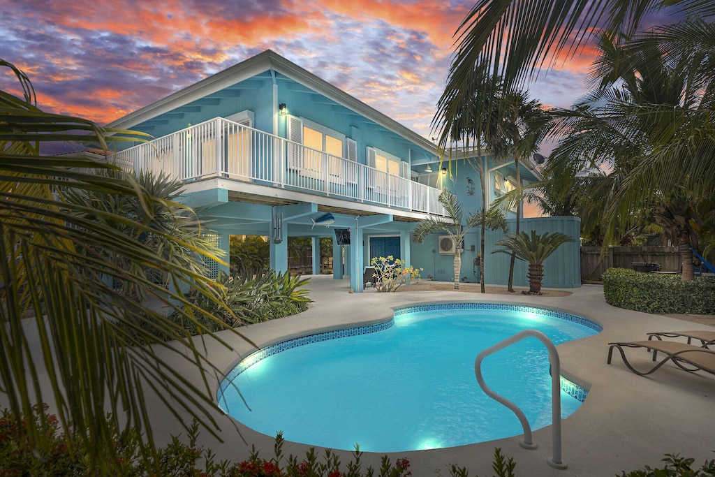 pool at dusk with a patio