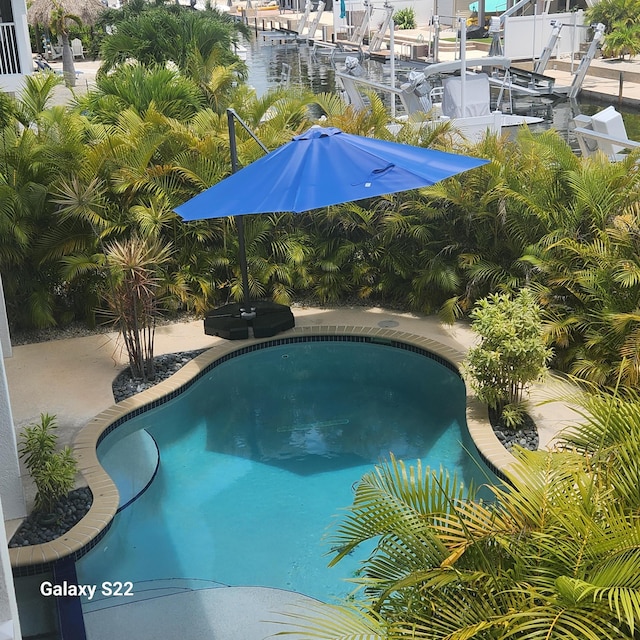 view of pool with a water view