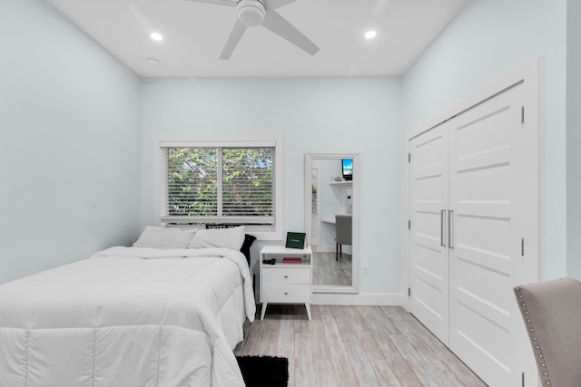 bedroom with a closet, ceiling fan, and light wood-type flooring