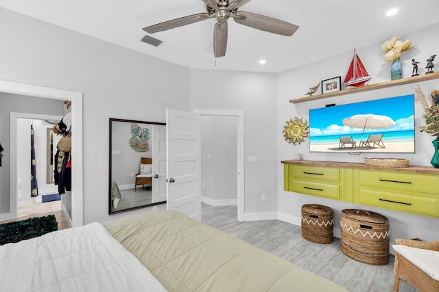 bedroom with ceiling fan and light hardwood / wood-style floors