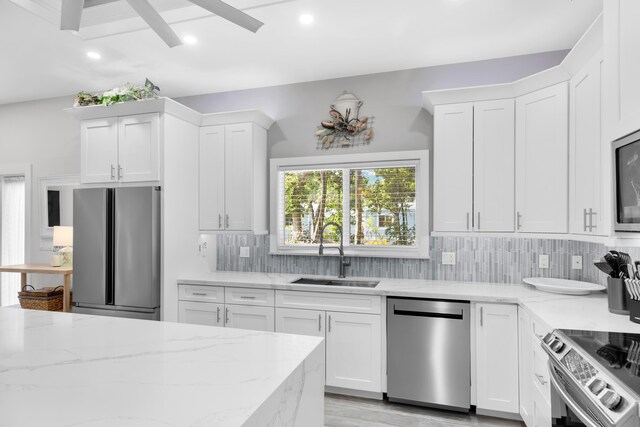 kitchen featuring stainless steel appliances and white cabinets