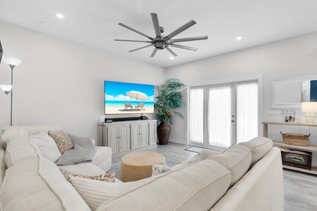 living room featuring ceiling fan and light hardwood / wood-style flooring