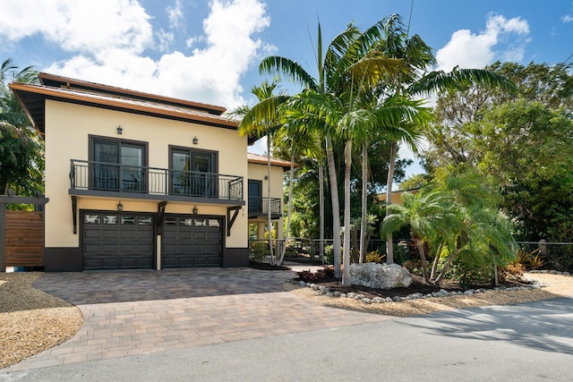 view of front of home with a balcony and a garage