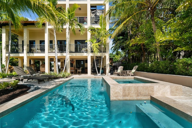 view of pool featuring a patio area and an in ground hot tub