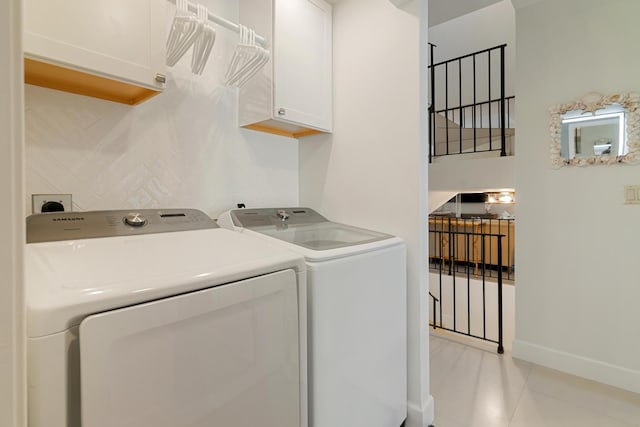 washroom with cabinets, light tile patterned floors, and independent washer and dryer