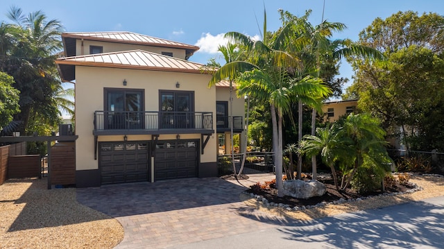 view of front of home featuring a balcony and a garage