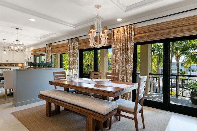 dining space featuring a raised ceiling, crown molding, a notable chandelier, and french doors