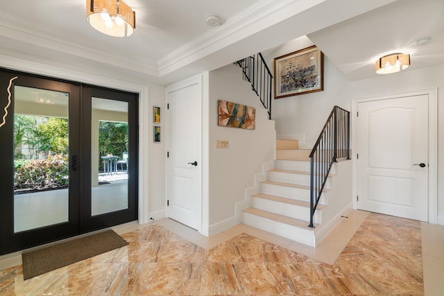 entrance foyer with ornamental molding and french doors