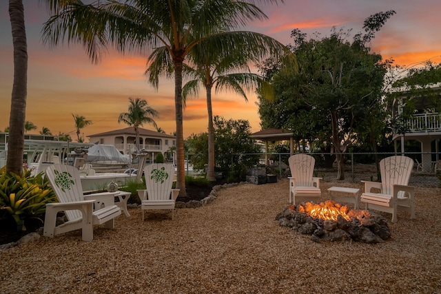 yard at dusk with an outdoor fire pit